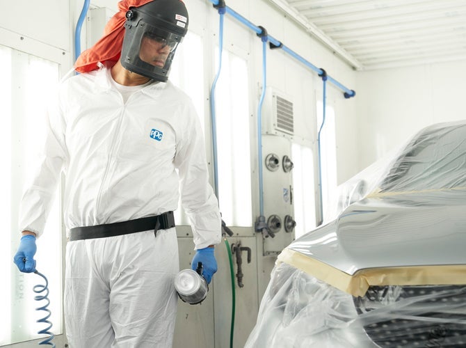 Worker in PPE equipment in spray booth