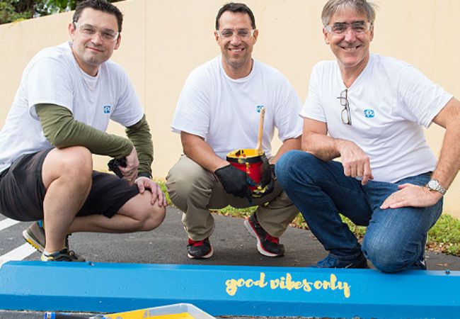 Three men with painting supplies