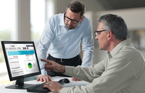 Worker assisting user with software on computer