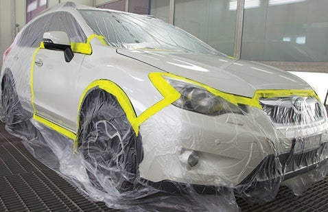 Car masked with plastic sheeting