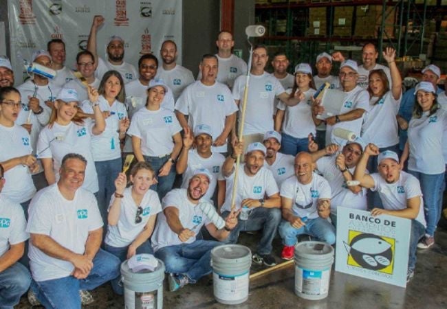 group of volunteers posing with painting supplies in Carolina, Puerto Rico 