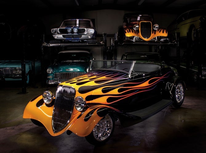 Custom sprayed cars on display in body shop