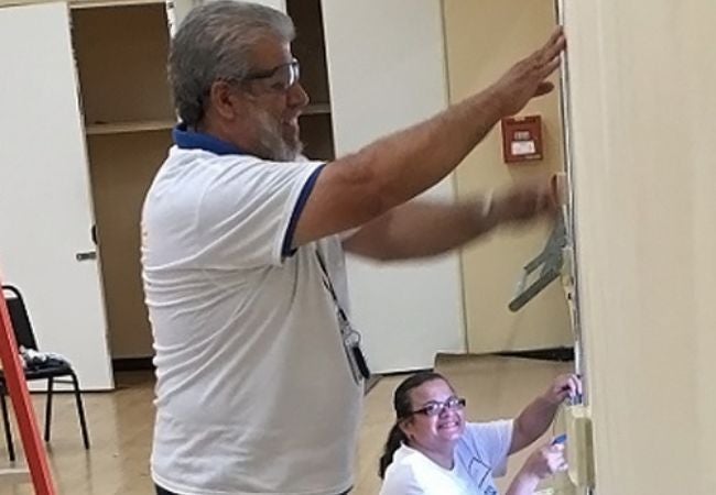 volunteer painting wall in Reseda CA 