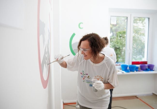 volunteer painting mural