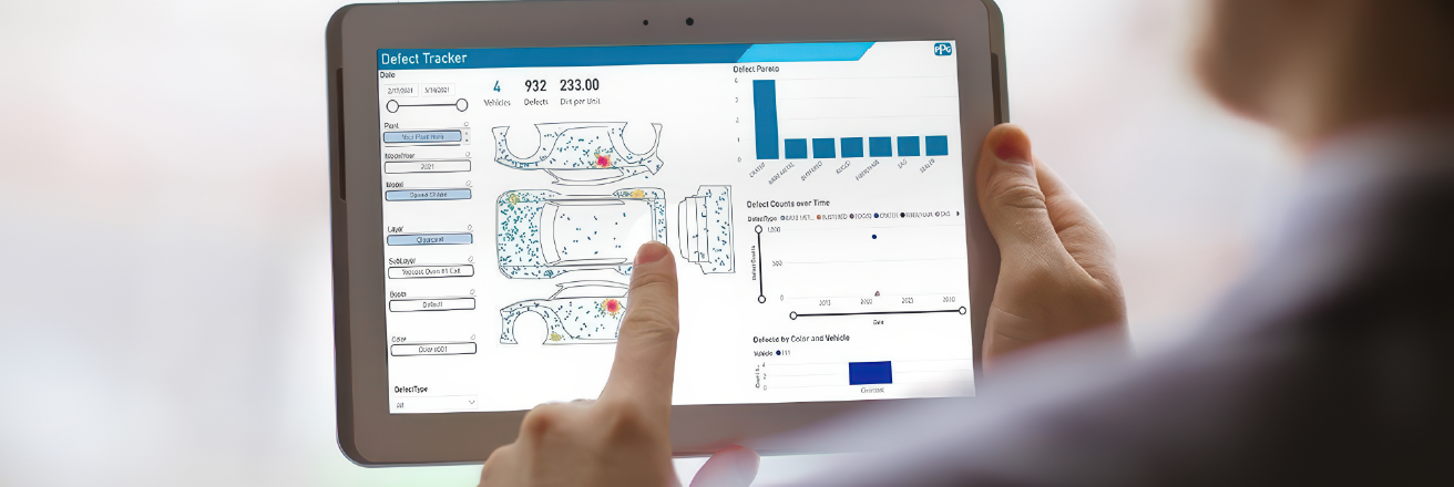 A person holds a tablet showing an diagram of a vehicle