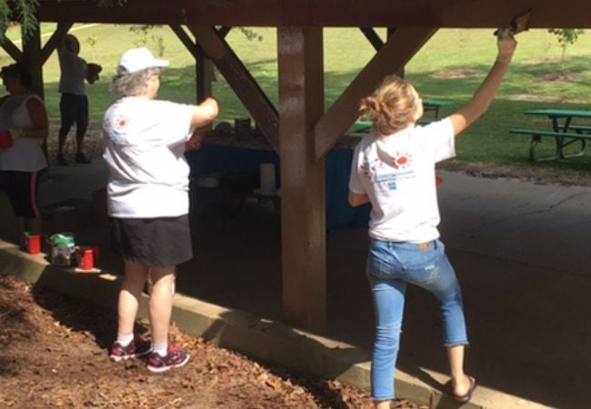 volunteers staining pavilion