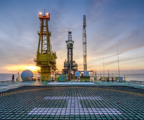 A large platform with cranes in the water