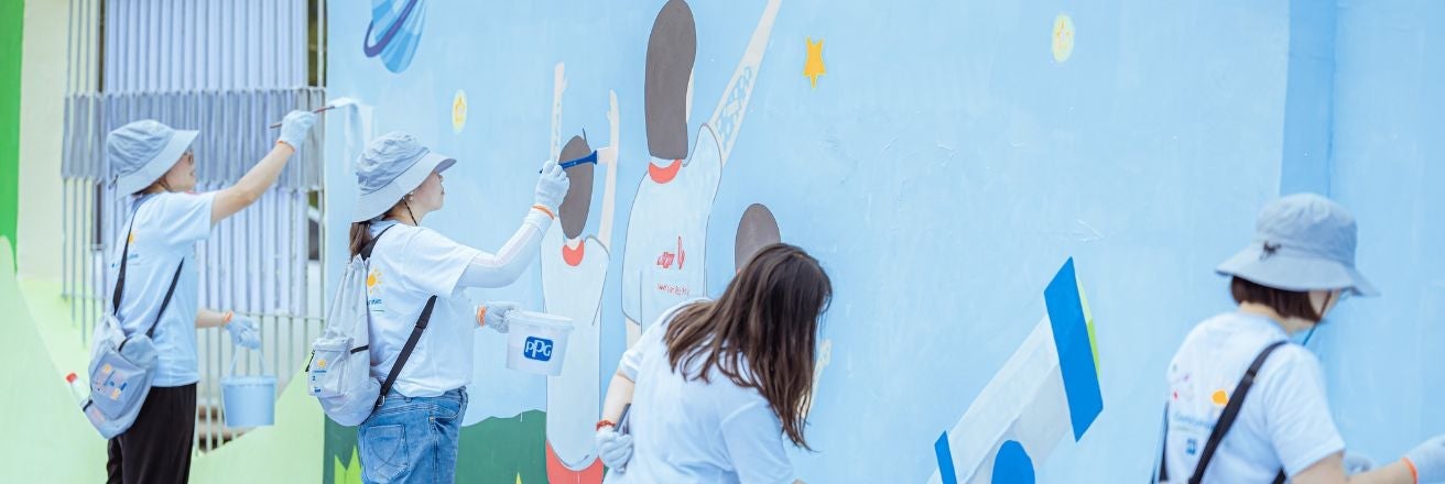 women painting mural