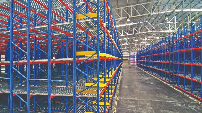 Red and blue shelving a racking structures in a large warehouse