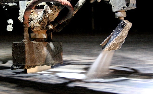 Coatings being applied to a roadway