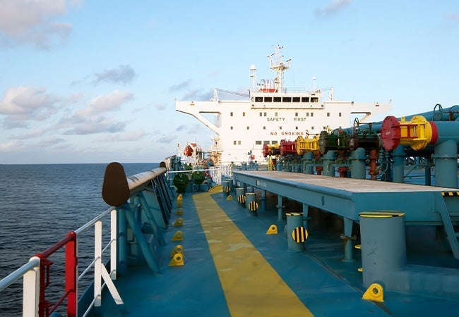 Container ship on the ocean demonstrating fuel efficiency with advanced hull coating technology