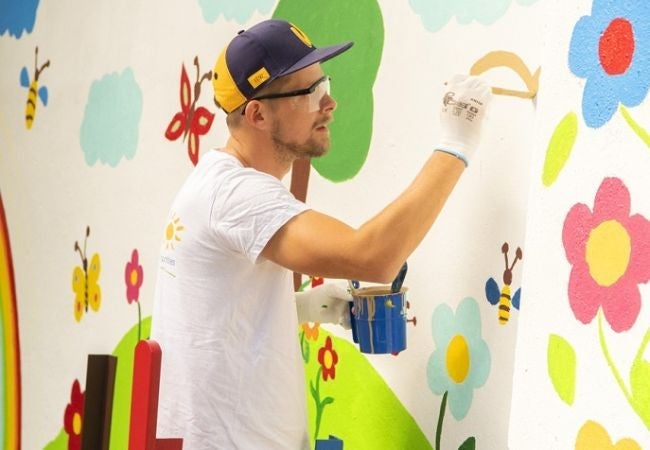 man painting mural