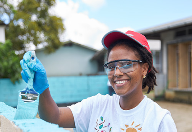 girl painting wall blue