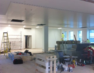 Room with several windows undergoing restoration.