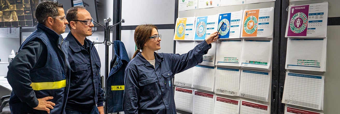 PPG workers in uniform discussing data