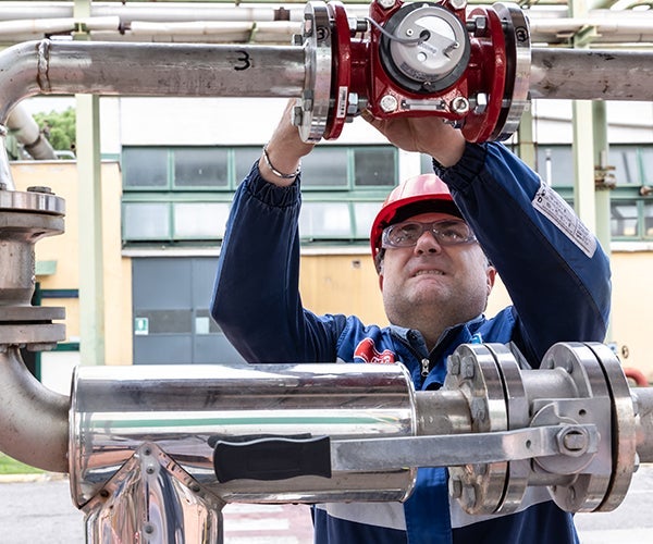 PPG worker carrying out adjustments to pipework