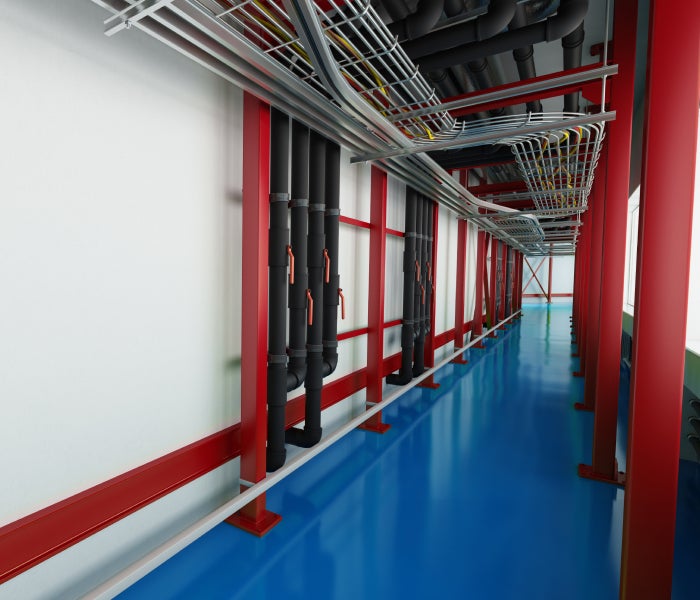 Interior industrial hallway showing pipes