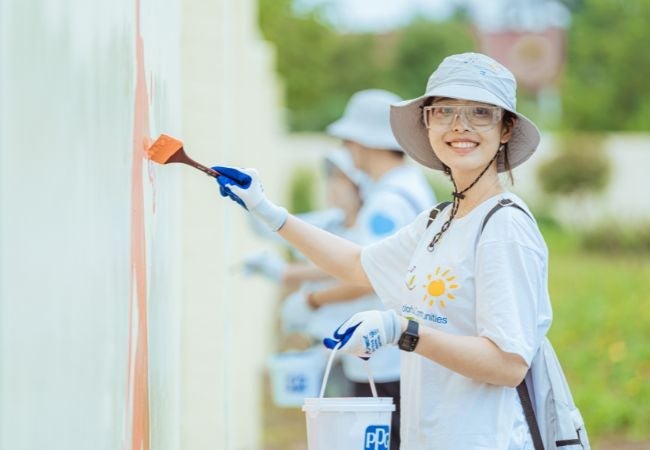 Women painting wall