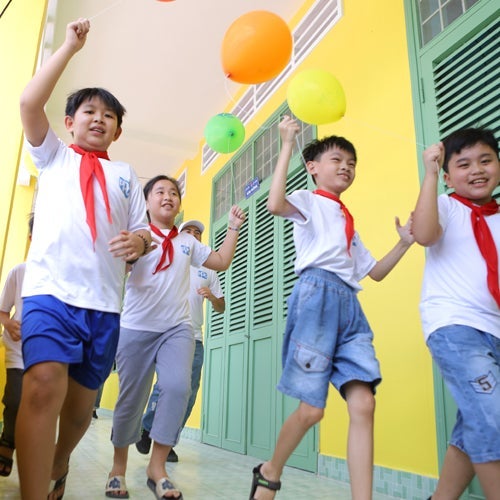 school children running through hallway 