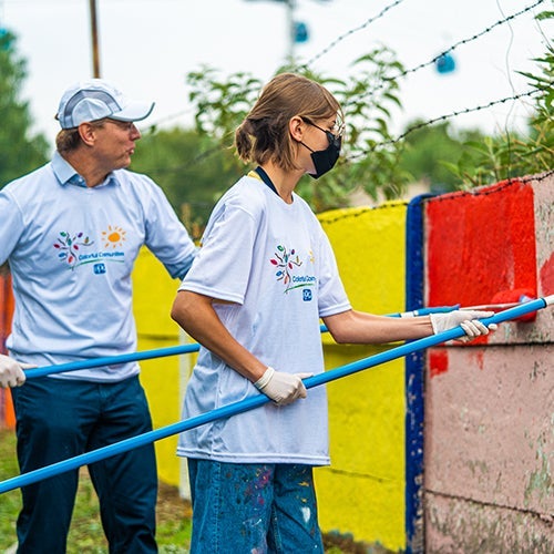 volunteers painting wall