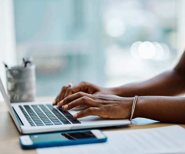 Lady sat at a laptop typing