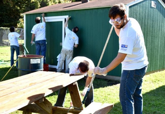 volunteers staining and painting in park in Pittsburgh, PA