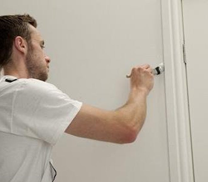 A man painting a door