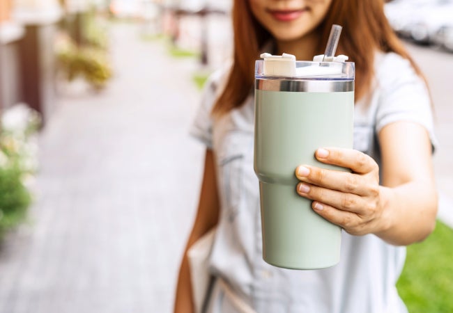 Girls showing a colored insulated mug