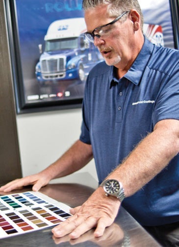 PPG workers examining color charts