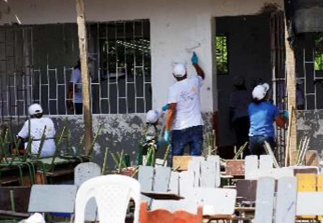 People Painting building tan in Cartagena, Columbia 