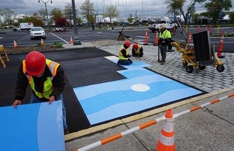 Workers applying colorful pedestrian walkway in Norwalk, CT