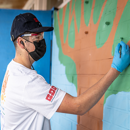 man painting mural