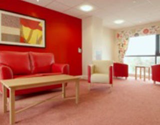 Interior view of a care home with red wall.