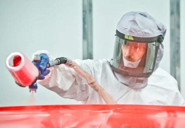 painter spraying car