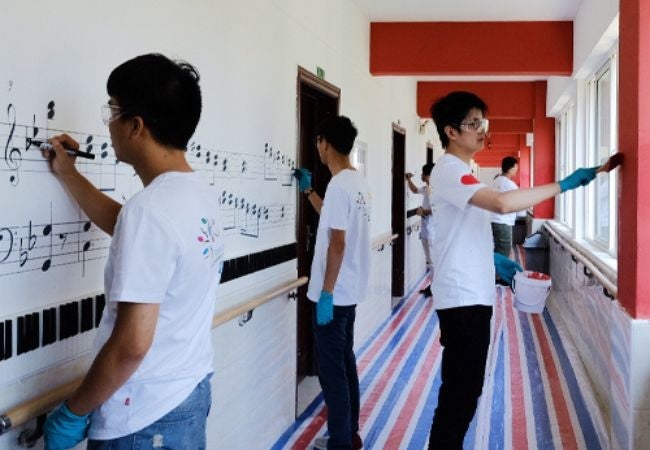 volunteers painting hallway in Wuhu, China