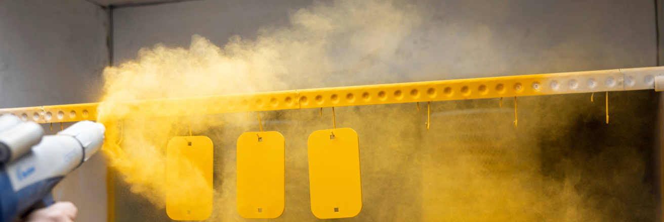 Hand spraying part with yellow powder coating