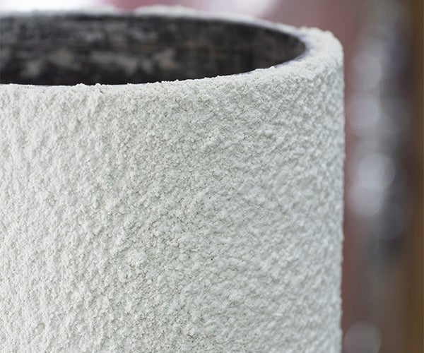 A white cylindrical object with a black rim