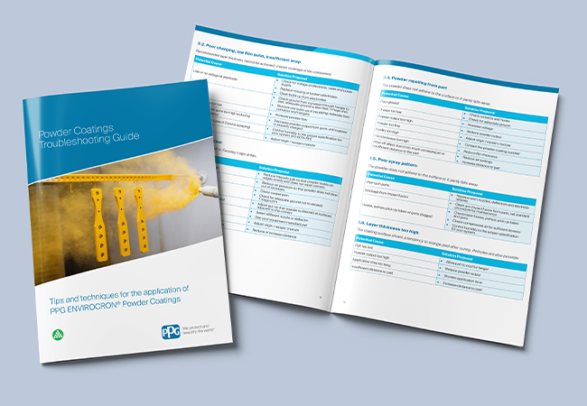 Powder coatings troubleshooting guide with a cover showing yellow powder being sprayed, open on a powder guide