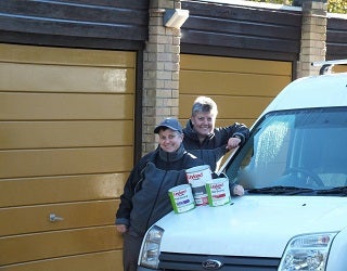 A couple of women standing next to a van