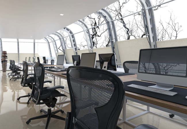 Office space with multiple black desk chairs and white desks