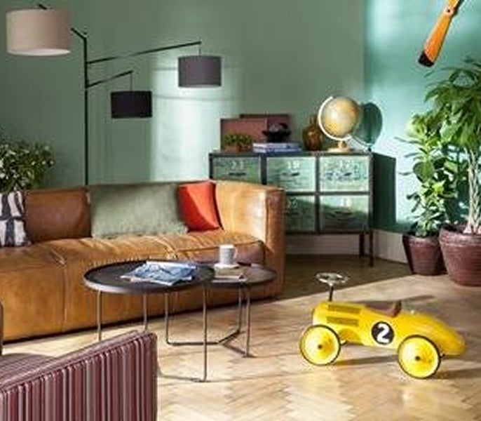 A living room with a couch and a yellow toy car