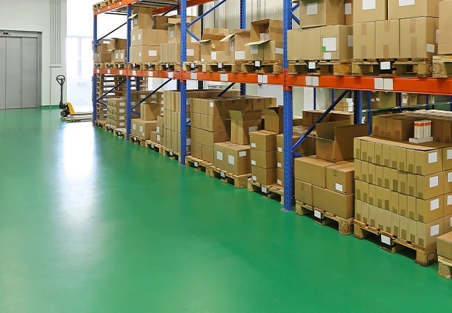 A warehouse with urethane coated floors and boxes on shelves