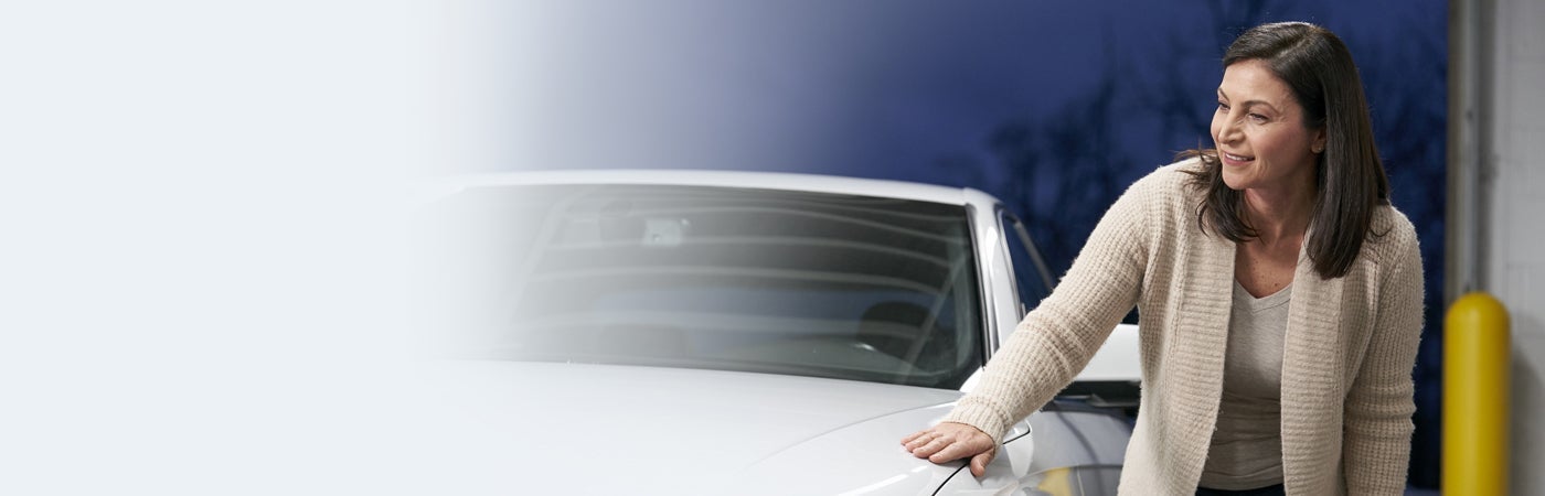 Woman inspecting car body work