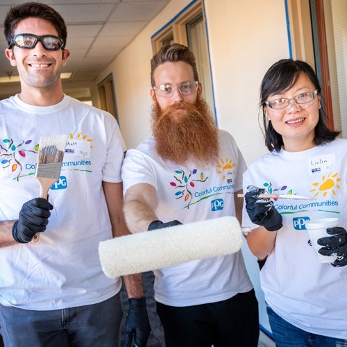 group of colorful communities volunteers ready to paint