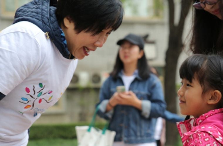 volunteer talking with child