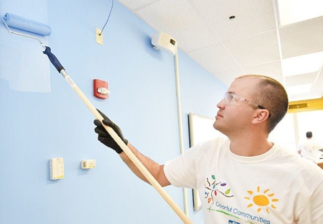 Man painting wall with roller