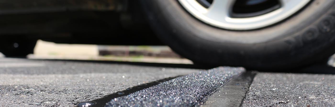 A car tire going over a rumble bar