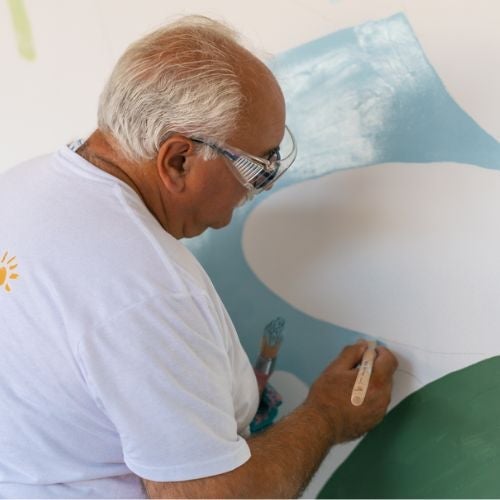 man painting mural