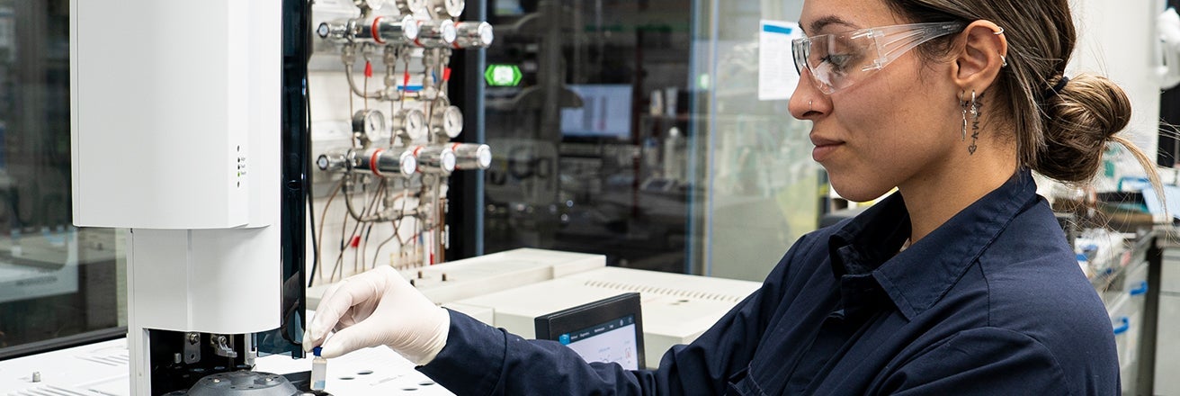 Female employee wearing PPE working within PPG laboratory