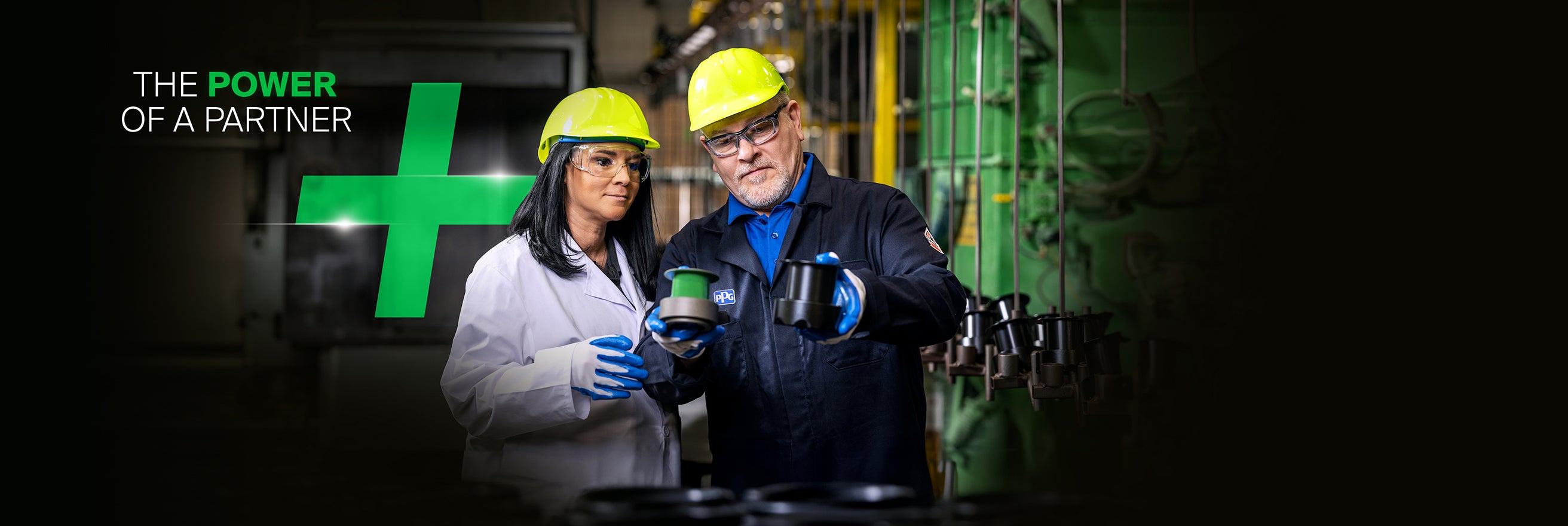 A male and female worker with yellow hard hats and protective clothing viewing sustainability advantaged products against a Power of Partner background and green plus symbol